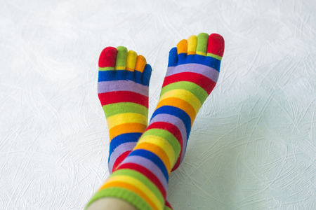 Close-up photo of the woman legs in zebrine socks on the white backgroundの写真素材