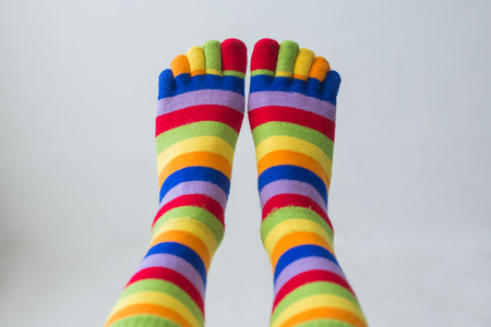 Close-up photo of the woman legs in zebrine socks on the white background