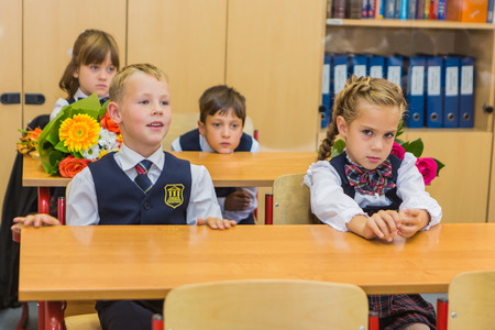 NOVOKUZNETSK, KEMEROVO REGION, RUSSIA - SEP, 1, 2016: First-grade students and teacher are in school classroom at first lesson. The day of knowledge in Russia.のeditorial素材