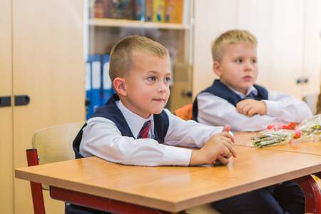 NOVOKUZNETSK, KEMEROVO REGION, RUSSIA - SEP, 1, 2016: First-grade students and teacher are in school classroom at first lesson. The day of knowledge in Russia.のeditorial素材