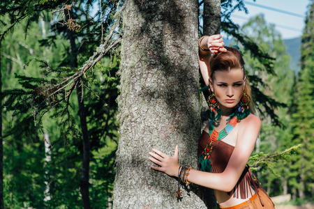 Young and beautiful savage girl in forestの写真素材
