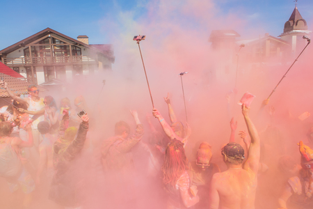 Sheregesh, Kemerovo region, Russia - April 16, 2016: Grelka Fest is a sports and entertainment activity for ski and snowboard riders in bikini. A group of a young people throwing colorful holi powder.のeditorial素材