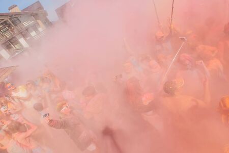 Sheregesh, Kemerovo region, Russia - April 16, 2016: Grelka Fest is a sports and entertainment activity for ski and snowboard riders in bikini. A group of a young people throwing colorful holi powder.のeditorial素材