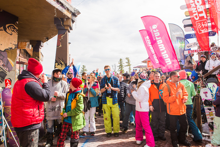 Sheregesh, Kemerovo region, Russia - April 16, 2016: Grelka Fest is a sports and entertainment activity for ski and snowboard riders in bikini in Russia, Sheregesh. Crowd of happy dancing people.のeditorial素材