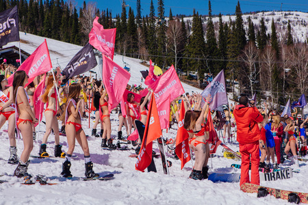 Sheregesh, Kemerovo region, Russia - April 22, 2017: Grelka Fest is a sports and entertainment activity for ski and snowboard riders in bikini. Many young women on a snowboard and ski in bikini.のeditorial素材
