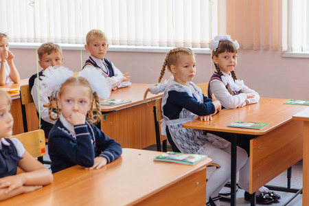 NOVOKUZNETSK, KEMEROVO REGION, RUSSIA - SEP, 1, 2017: First-grade students and teacher are in school classroom at first lesson. The day of knowledge in Russia.のeditorial素材