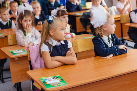 NOVOKUZNETSK, KEMEROVO REGION, RUSSIA - SEP, 1, 2017: First-grade students and teacher are in school classroom at first lesson. The day of knowledge in Russia.のeditorial素材