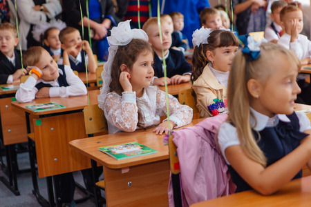 NOVOKUZNETSK, KEMEROVO REGION, RUSSIA - SEP, 1, 2017: First-grade students and teacher are in school classroom at first lesson. The day of knowledge in Russia.のeditorial素材