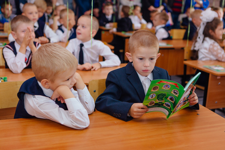 NOVOKUZNETSK, KEMEROVO REGION, RUSSIA - SEP, 1, 2017: First-grade students and teacher are in school classroom at first lesson. The day of knowledge in Russia.のeditorial素材