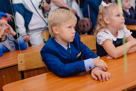 NOVOKUZNETSK, KEMEROVO REGION, RUSSIA - SEP, 1, 2017: First-grade students and teacher are in school classroom at first lesson. The day of knowledge in Russia.のeditorial素材