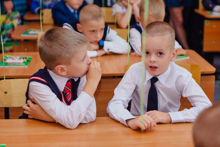 NOVOKUZNETSK, KEMEROVO REGION, RUSSIA - SEP, 1, 2017: First-grade students and teacher are in school classroom at first lesson. The day of knowledge in Russia.のeditorial素材