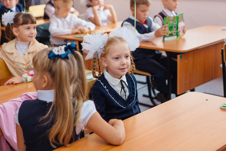 NOVOKUZNETSK, KEMEROVO REGION, RUSSIA - SEP, 1, 2017: First-grade students and teacher are in school classroom at first lesson. The day of knowledge in Russia.のeditorial素材