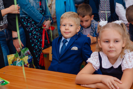 NOVOKUZNETSK, KEMEROVO REGION, RUSSIA - SEP, 1, 2017: First-grade students and teacher are in school classroom at first lesson. The day of knowledge in Russia.のeditorial素材