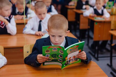 NOVOKUZNETSK, KEMEROVO REGION, RUSSIA - SEP, 1, 2017: First-grade students and teacher are in school classroom at first lesson. The day of knowledge in Russia.のeditorial素材