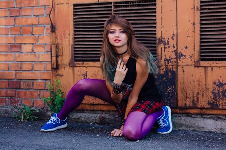 Young beautiful rock and roll girl with bright colorful makeupの写真素材