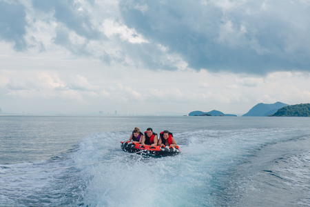 Chonburi, Thailand - November 26, 2013 :: Tourists on water attraction donut boat during summer vacationsのeditorial素材