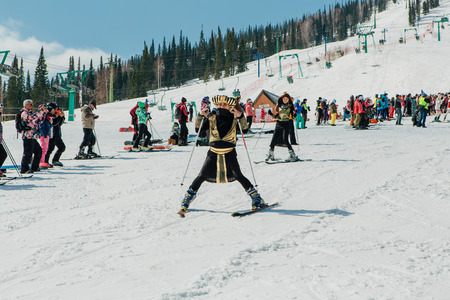 Sheregesh, Kemerovo region, Russia - April 22, 2017: Grelka Fest is a sports and entertainment activity for ski and snowboard riders in carnival costume. Young people in carnival costumes.のeditorial素材