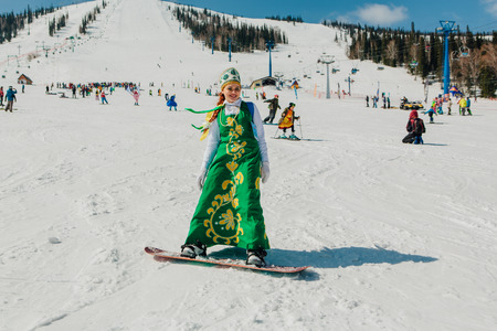 Sheregesh, Kemerovo region, Russia - April 22, 2017: Grelka Fest is a sports and entertainment activity for ski and snowboard riders in carnival costume. Young people in carnival costumes.のeditorial素材