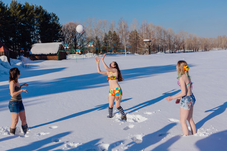 Novokuznetsk, Kemerovo region, Russia-23 Feb, 2017: White beaches of Siberia is an enterteiment activity where people playing beach games dressed in bikini in winter. Women playing volleyball on snowのeditorial素材