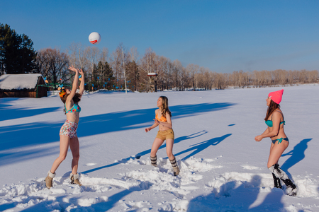 Novokuznetsk, Kemerovo region, Russia-23 Feb, 2017: White beaches of Siberia is an enterteiment activity where people playing beach games dressed in bikini in winter. Women playing volleyball on snowのeditorial素材