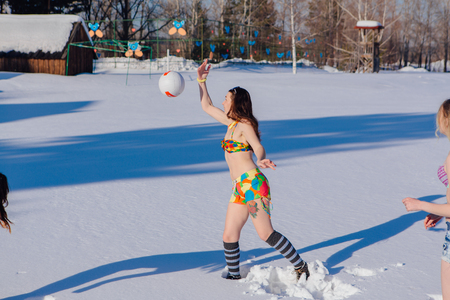 Novokuznetsk, Kemerovo region, Russia-23 Feb, 2017: White beaches of Siberia is an enterteiment activity where people playing beach games dressed in bikini in winter. Women playing volleyball on snowのeditorial素材