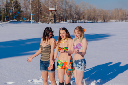 Novokuznetsk, Kemerovo region, Russia-23 Feb, 2017: White beaches of Siberia is an enterteiment activity where people playing beach games dressed in bikini in winter. Women in bikini playing with snowのeditorial素材