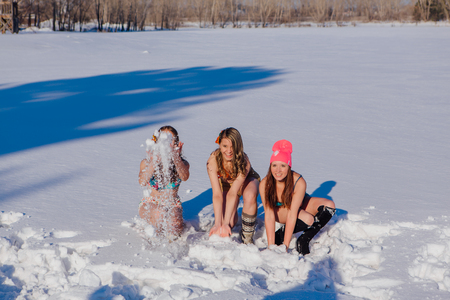 Novokuznetsk, Kemerovo region, Russia-23 Feb, 2017: White beaches of Siberia is an enterteiment activity where people playing beach games dressed in bikini in winter. Women in bikini playing with snowのeditorial素材