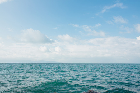 Blue sea with white clouds abstract background patternの写真素材