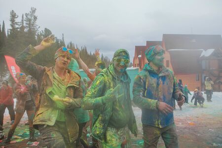A group of a young people throwing colorful holi powder.