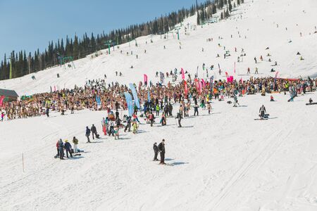 Crowd of people in bikini and shorts with snowboard and mountain ski on the slopeのeditorial素材