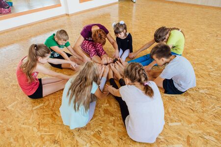 Yoga lesson for kids with teacher in a room