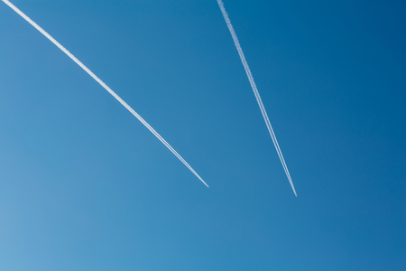 Two planes with traces on a blue sky background. Copy spaceの写真素材