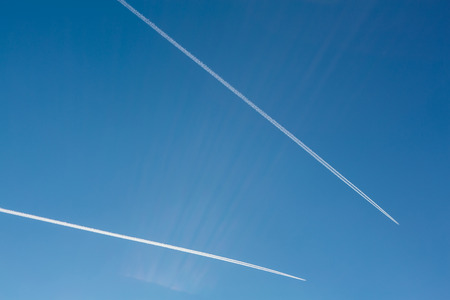 Two planes with traces on a blue sky background. Copy spaceの写真素材