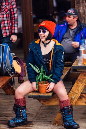 Sheregesh, Kemerovo region, Russia - April 7, 2018: Grelka Fest is a sport and entertainment activity for ski and snowboard riders in carnival costume. Young woman dressed like Matilda from Leon movieのeditorial素材