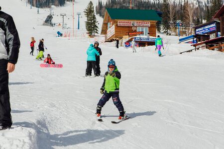 Sheregesh, Mountain Shoria, Kemerovo Region, Russia - April 6, 2018 : Little boy in motion on mountain ski on the slopeのeditorial素材