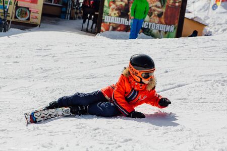 Sheregesh, Mountain Shoria, Kemerovo Region, Russia - April 6, 2018 : Little boy on mountain ski relaxing on the slopeのeditorial素材
