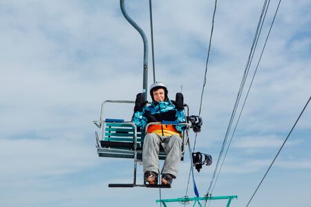 Sheregesh, Mountain Shoria, Kemerovo Region, Russia - April 6, 2018 : Snowboarder on a ski lift in ski resortのeditorial素材