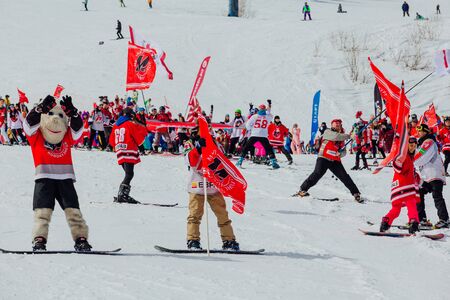 Sheregesh, Kemerovo region, Russia - April 7, 2018: Grelka Fest is a sports and entertainment activity for ski and snowboard riders. Young people in hockey team Metallurg t-shirts on a mountain slope.のeditorial素材