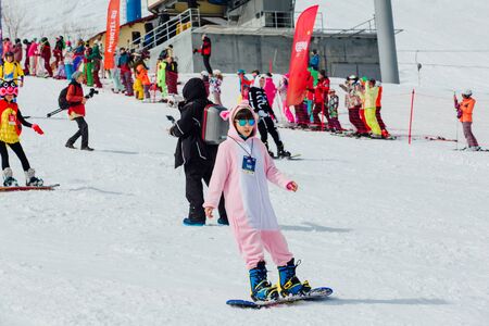 Sheregesh, Kemerovo region, Russia - April 7, 2018: Grelka Fest is a sports and entertainment activity for ski and snowboard riders in carnival costume. Young people in carnival costumes.のeditorial素材