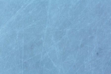 ice background with marks from skating and hockey. Ice hockey rink scratches surfaceの写真素材