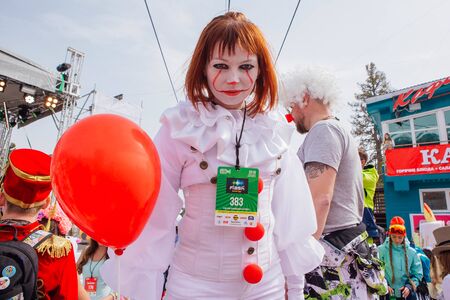 Sheregesh, Kemerovo region, Russia - April 7, 2018: Grelka Fest is a sports and entertainment activity for ski and snowboard riders in carnival costume. Young woman dressed like Pennywise from movieのeditorial素材