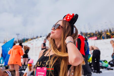 Sheregesh, Kemerovo region, Russia - April 14, 2018: Grelka Fest is a sports and entertainment activity for ski and snowboard riders in bikini in Russia, Sheregesh. Young happy pretty woman in bikini.のeditorial素材