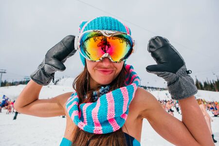 Sheregesh, Kemerovo region, Russia - April 14, 2018: Grelka Fest is a sports and entertainment activity for ski and snowboard riders in bikini in Russia, Sheregesh. Woman in bikini with snowboard.のeditorial素材