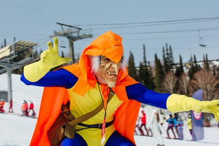 Sheregesh, Kemerovo region, Russia - April 7, 2018: Grelka Fest is a sports and entertainment activity for ski and snowboard riders in carnival costume. Man in a costume of Green Goblin on snowboardのeditorial素材
