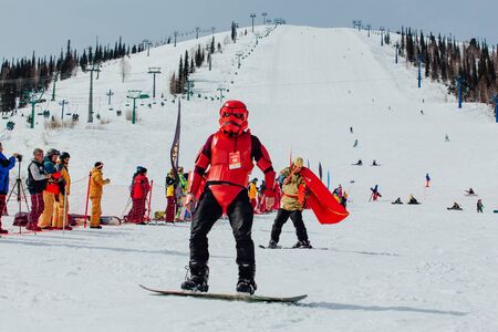 Sheregesh, Kemerovo region, Russia - April 7, 2018: Grelka Fest is a sports and entertainment activity for ski and snowboard riders in carnival costume. Young people in carnival costumes.のeditorial素材