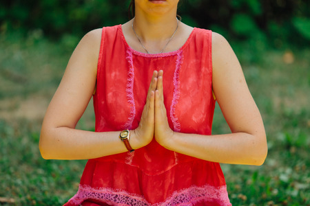 Woman makes yoga in summer park.の写真素材
