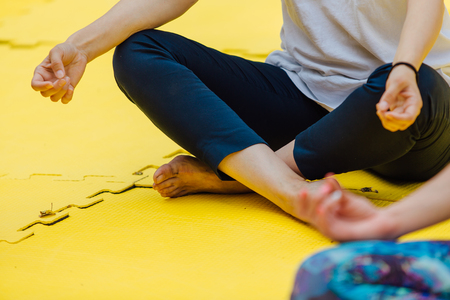 Woman makes yoga in summer park.の写真素材