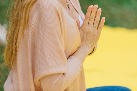 Woman makes yoga in summer park.の写真素材