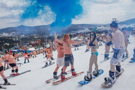 Sheregesh, Kemerovo region, Russia - April 14, 2018: Grelka Fest is a sports and entertainment activity for ski and snowboard riders in bikini. Crowd of people riding snowboard and mountain skiのeditorial素材