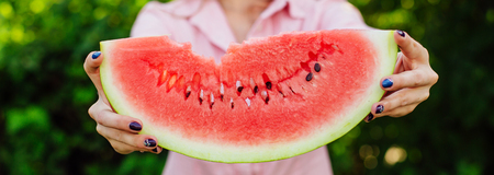 Banner with woman's hands holding fresh sweet juicy watermelonの写真素材